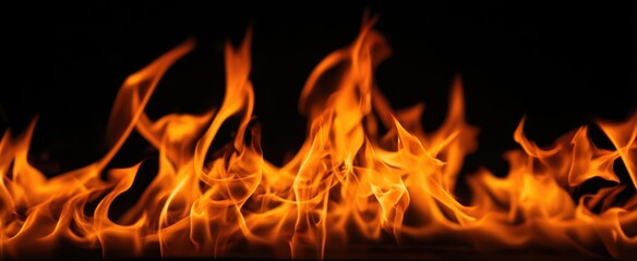 Fototapeta premium The mesmerizing dance of flames against a dark backdrop.