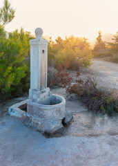 Memory carved in stone — old fountain stands quietly beneath golden hour light, holding hush of...