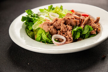 Tuna salad green leaf lettuce, canned tuna, tomato fresh delicious gourmet food background on the table rustic food top view copy space keto and paleo diet vegetarian food pescetarian diet