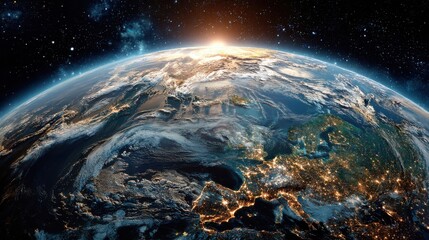 Obraz premium A breathtaking view of Earth from space at sunrise, highlighting illuminated city areas and coastlines across Europe, surrounded by the vastness of space.
