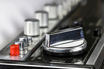 An old, slightly dusty tape recorder with a selector switch to control the tape operation