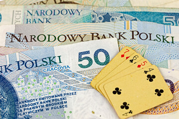 Some playing cards on some Polish Zloty banknotes