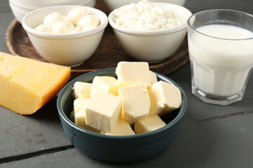 Different dairy products on grey wooden table, closeup