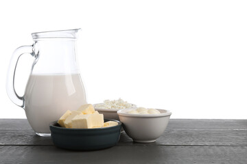 Different dairy products on grey wooden table against white background