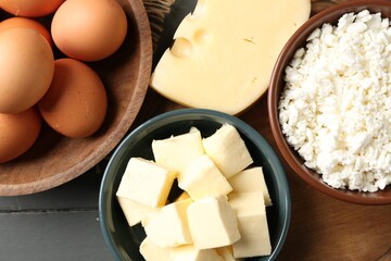 Different dairy products and eggs on grey wooden table, flat lay