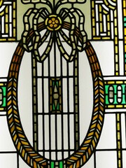 Beautiful stained glass design showcasing an elegant oval frame and intricate patterns in vibrant...
