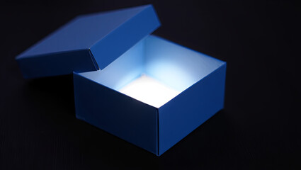 A blue box is open, revealing a soft light emanating from inside. The dark background adds to the mystery and allure of the glowing box, inviting curiosity and imagination
