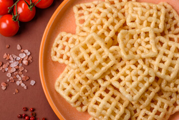 Lattice or wafer potato chips, crispy yellow snacks, takeaway food