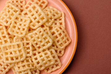 Lattice or wafer potato chips, crispy yellow snacks, takeaway food