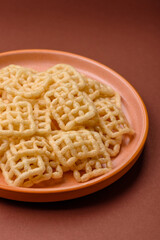 Lattice or wafer potato chips, crispy yellow snacks, takeaway food