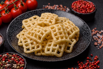 Lattice or wafer potato chips, crispy yellow snacks, takeaway food