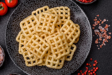 Lattice or wafer potato chips, crispy yellow snacks, takeaway food