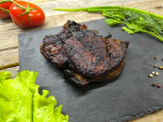 Delicious fried steak on a granite edged board