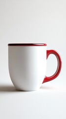 Obraz premium A ceramic mug appears simple and white, accented with a vibrant red trim