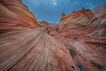 The Wave in Vermilion Cliffs, USA, showcases surreal sandstone formations with wave-like patterns...
