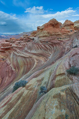 The Wave in Vermilion Cliffs, USA, showcases surreal sandstone formations with wave-like patterns...