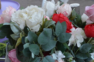 Close-up of a vibrant bouquet of artificial flowers with a mix of colors.