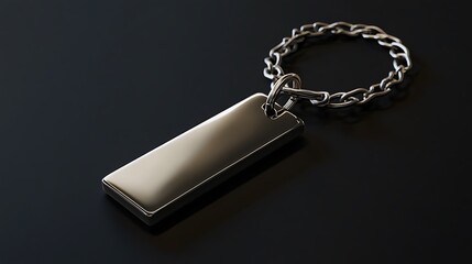 Sleek metal rectangle keyring attached with circular chain glistens against the dark surface, showing modern simplicity