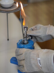 Person is holding a blue object with a flame on it