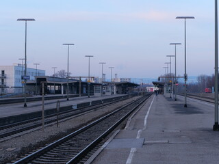 Train station with a few trains parked on the tracks