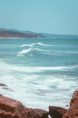 Rocky Shoreline with ocean waves rolling in portugal