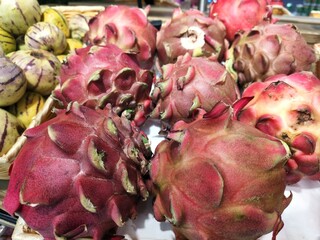 A bunch of red fruits with a few green leaves