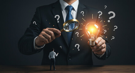 Businessman holding magnifying glass and lightbulb surrounded by question marks on dark background