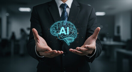 A man in a suit holding a glowing brain with ai text in his hands in a blurred office setting