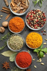 Different aromatic spices on grey table, flat lay
