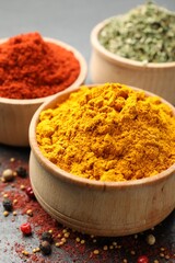 Different aromatic spices on black table, closeup