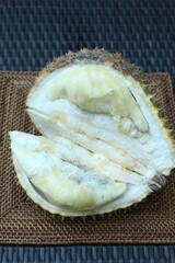 Fresh ripe durian on wicker table, above view