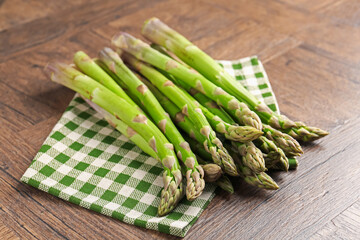 Fresh raw asparagus on wooden table, closeup