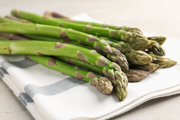 Fresh raw asparagus on light grey table, closeup
