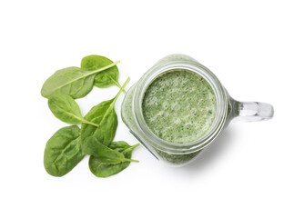 Tasty smoothie in mason jar and spinach leaves isolated on white, top view