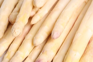 Raw white asparagus spears as background, closeup