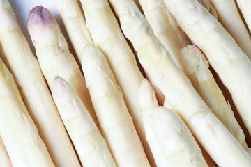 Raw white asparagus spears as background, closeup