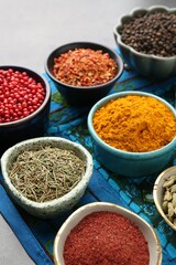 Different aromatic spices on grey table, closeup