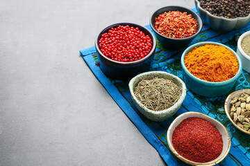 Different aromatic spices on grey table, closeup. Space for text