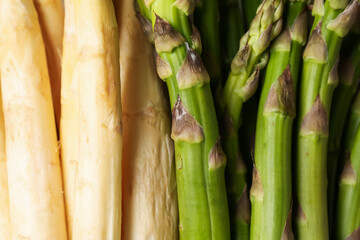 Different raw asparagus spears as background, top view