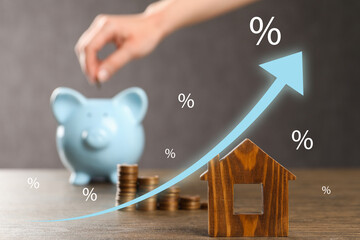 Increase in real estate value. Arrow with percent signs above house model. Woman putting coin into...