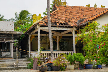 Aging Colonial Villa with Red Tiled Roof and Lush Garden in Coastal Mui Ne, Vietnam