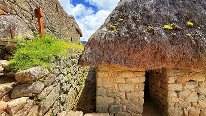 Traditional Inca Stone House with Thatched Roof in Historic Machu Picchu