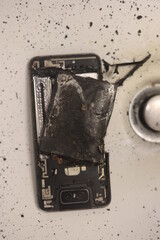 Phone is on a sink with a burnt battery