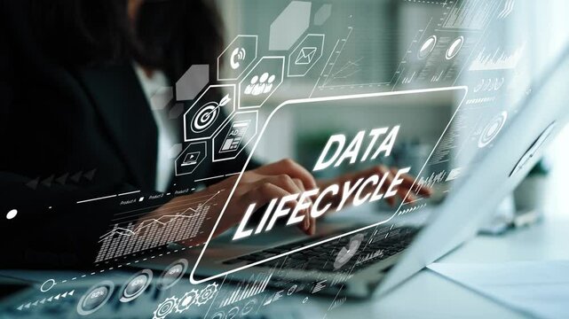 Business professional working on laptop with data lifecycle graphics in modern office environment showcasing technology and analytics. Asymptotic smart data analytic.