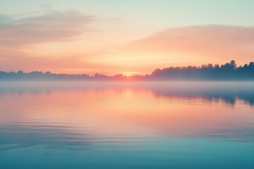 Fototapeta premium Evening sky displays warm hues of orange and pink over tranquil waters at sunset