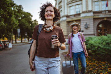 Fototapeta premium smile woman with thermos and backpack strolling, tourism concept