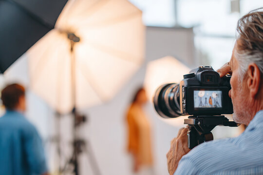Professional photographer capturing a model during an indoor studio photo shoot session