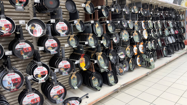 Warsaw, Poland - June 28, 2025: Tefal cookware display with various frying pans in a retail store setting