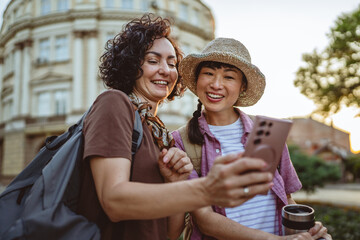 two women use mobile phone for directions walk and touring city