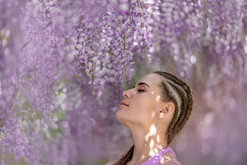 Woman wisteria lilac dress. Thoughtful happy mature woman in pur